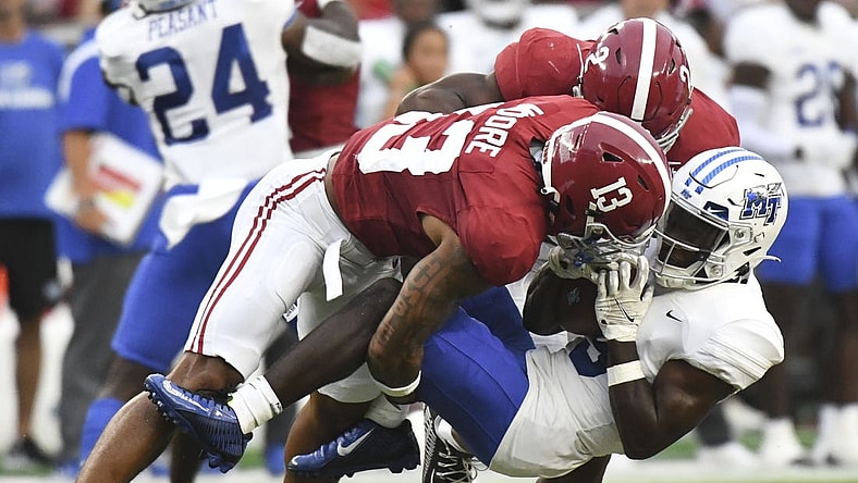 Sep 2, 2023; Tuscaloosa, Alabama, USA;  Alabama Crimson Tide defensive back Malachi Moore (13) and defensive back Caleb Downs (2) combine to tackle Middle Tennessee Blue Raiders wide receiver Elijah Metcalf (9) during the first half at Bryant-Denny Stadium. Mandatory Credit: Gary Cosby Jr.-USA TODAY Sports