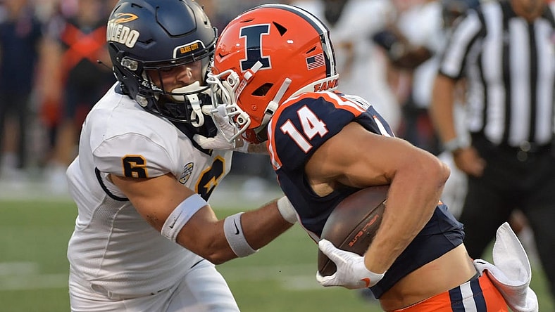 Sep 2, 2023; Champaign, Illinois, USA;  Toledo Rockets safety Nate Bauer (6) tries to tackle Illinois Fighting Illini wide receiver Casey Washington (14) during the first half at Memorial Stadium. Mandatory Credit: Ron Johnson-USA TODAY Sports