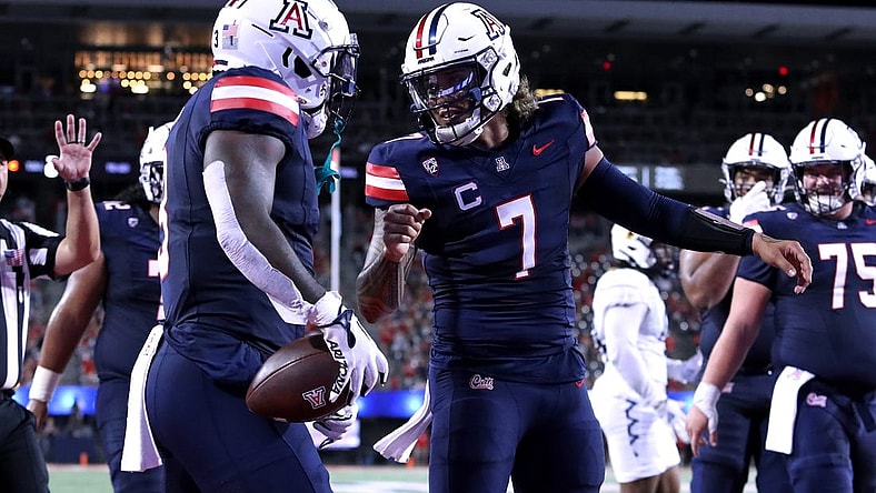 Sep 2, 2023; Tucson, Arizona, USA; Arizona Wildcats quarterback Jayden de Laura (7) celebrates a touchdown with running back Jonah Coleman (3) against the Northern Arizona Lumberjacks during the first half at Arizona Stadium. Mandatory Credit: Zac BonDurant-USA TODAY Sports