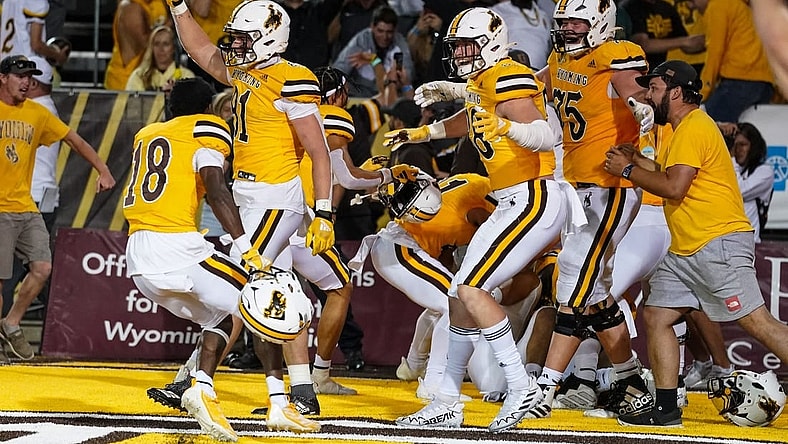 Sep 2, 2023; Laramie, Wyoming, USA; Wyoming Cowboys  rush the field after a double overtime win against the Texas Tech Red Raiders at Jonah Field at War Memorial Stadium. Mandatory Credit: Troy Babbitt-USA TODAY Sports