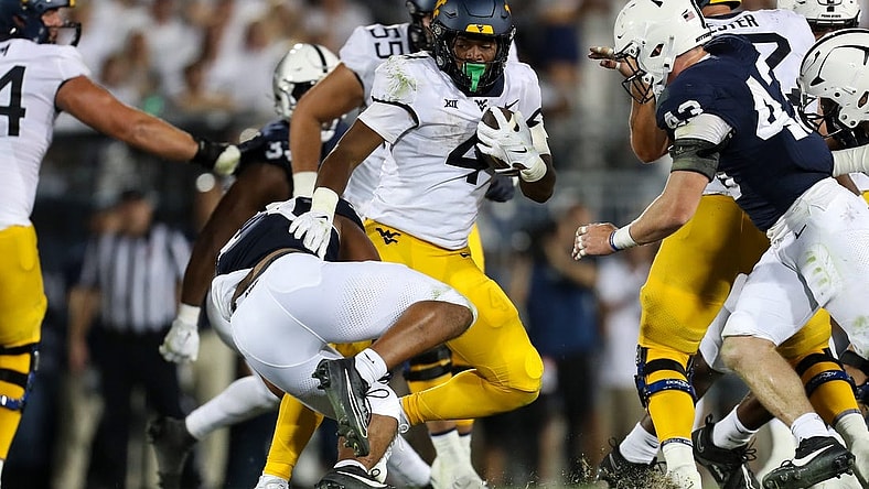 Sep 2, 2023; University Park, Pennsylvania, USA; West Virginia Mountaineers running back CJ Donaldson Jr. (4) runs the ball against the Penn State Nittany Lions during the fourth quarter at Beaver Stadium. Penn State won 38-15. Mandatory Credit: Matthew O'Haren-USA TODAY Sports