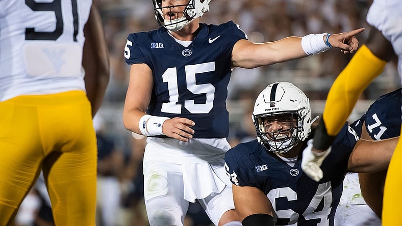 Penn State quarterback Drew Allar (15) and center Hunter Nourzad (64) point out a detail in the West Virginia defense during the season opener at Beaver Stadium September 2, 2023, in State College.