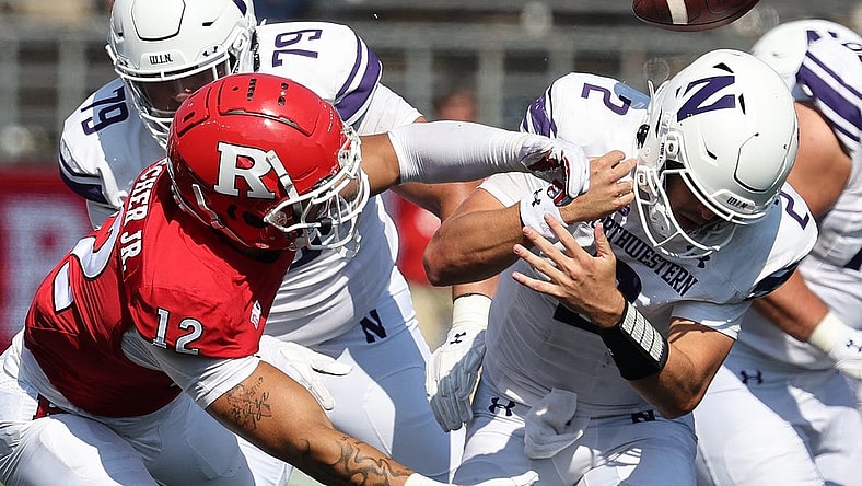 Sep 3, 2023; Piscataway, New Jersey, USA; Rutgers Scarlet Knights defensive lineman Kenny Fletcher (12) forces a fumble by Northwestern Wildcats quarterback Ben Bryant (2) during the second half at SHI Stadium. Mandatory Credit: Vincent Carchietta-USA TODAY Sports