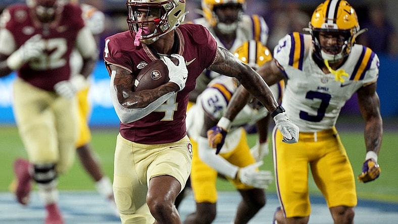 Sep 3, 2023; Orlando, Florida, USA; Florida State Seminoles wide receiver Keon Coleman (4) runs the ball for a touchdown during the first half against the Louisiana State Tigers at Camping World Stadium. Mandatory Credit: Melina Myers-USA TODAY Sports