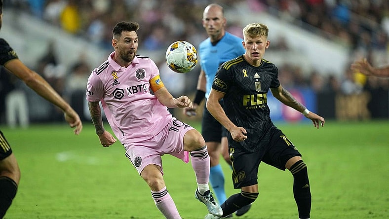 Sep 3, 2023; Los Angeles, California, USA; Inter Miami CF forward Lionel Messi (10) and LAFC midfielder Mateusz Bogusz (19) battle for the ball at BMO Stadium. Mandatory Credit: Kirby Lee-USA TODAY Sports
