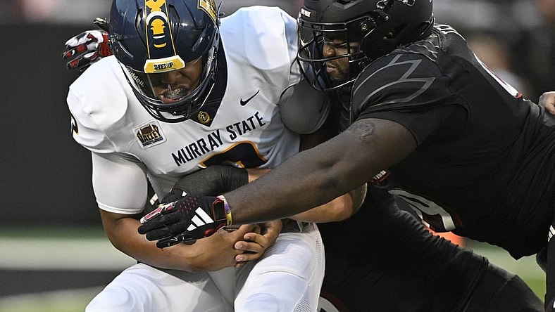 Sep 7, 2023; Louisville, Kentucky, USA; Louisville Cardinals defensive lineman Dezmond Tell (99) sacks Murray State Racers quarterback DJ Williams (2) during the first quarter at L&N Federal Credit Union Stadium. Mandatory Credit: Jamie Rhodes-USA TODAY Sports