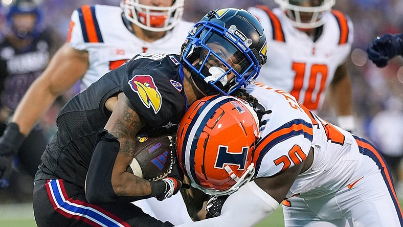 Sep 8, 2023; Lawrence, Kansas, USA; Kansas Jayhawks wide receiver Quentin Skinner (0) is tackled by Illinois Fighting Illini defensive back Tyler Strain (20) during the first half at David Booth Kansas Memorial Stadium. Mandatory Credit: Jay Biggerstaff-USA TODAY Sports