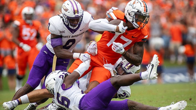 September 9, 2023 in Charlottesvile, Virginia; Virginia Cavaliers wide receiver JR Wilson (17) is tackled by James Madison Dukes linebacker Taurus Jones (0) in the first half at Scott Stadium. Mandatory Credit: Hannah Pajewski-USA TODAY Sports