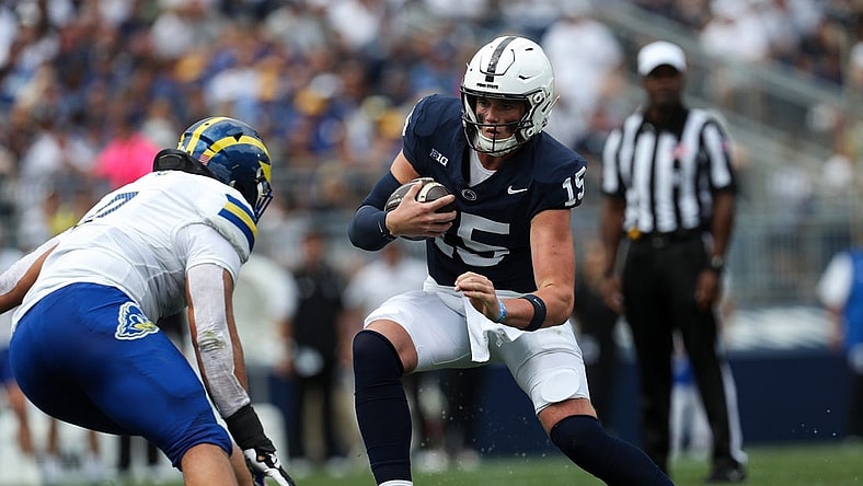 Sep 9, 2023; University Park, Pennsylvania, USA; Penn State Nittany Lions quarterback Drew Allar (15) looks to avoid a tackle while running with the ball during the first quarter against the Delaware Fightin' Blue Hens at Beaver Stadium. Mandatory Credit: Matthew O'Haren-USA TODAY Sports
