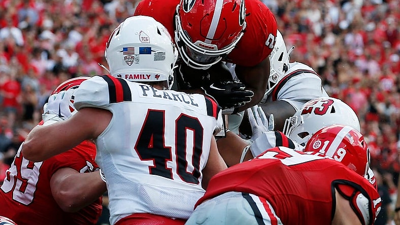 Georgia running back Kendall Milton (2) goes over the top to score a touchdown during the first half of a NCAA college football game against Ball State in Athens, Ga., on Saturday, Sept. 9, 2023.