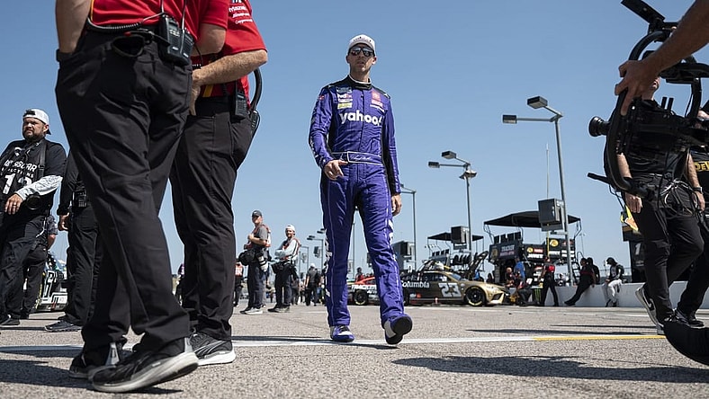 Sep 9, 2023; Kansas City, Kansas, USA; NASCAR Cup Series driver Denny Hamlin (11) walks to his car during NASCAR Cup Qualifying at Kansas Speedway. Mandatory Credit: Amy Kontras-USA TODAY Sports