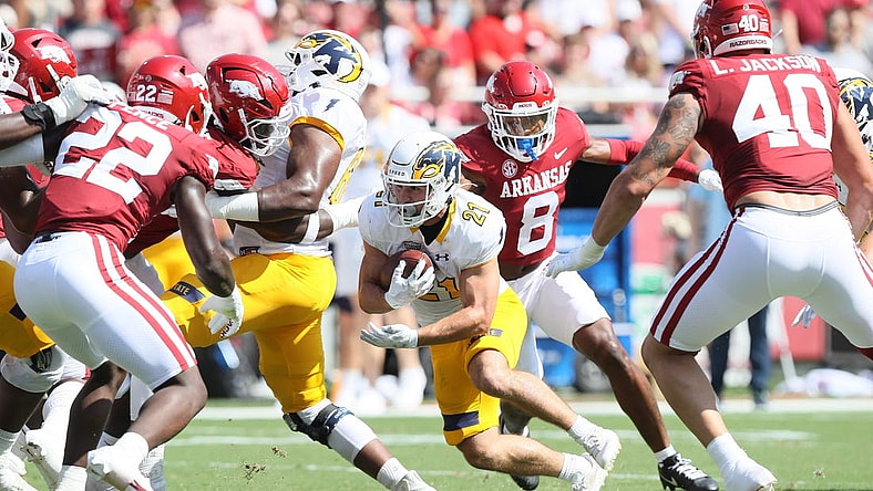 Sep 9, 2023; Fayetteville, Arkansas, USA; Kent State Golden Flashes running back Gavin Garcia (21) rushes in the first quarter against the Arkansas Razorbacks at Donald W. Reynolds Razorback Stadium. Mandatory Credit: Nelson Chenault-USA TODAY Sports