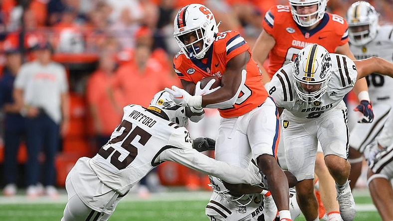 Sep 9, 2023; Syracuse, New York, USA; Syracuse Orange running back Juwaun Price (28) runs with the ball as Western Michigan Broncos cornerback Aaron Wofford (25) defends during the first half at the JMA Wireless Dome. Mandatory Credit: Rich Barnes-USA TODAY Sports