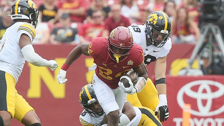 Iowa State Cyclones running back Abu Sama (24) breaks a tackle from Iowa Hawkeyes' defensive back Deshaun Lee (8) and Iowa Hawkeyes defensive line Yahya Black (94) during the second quarter of the Cy-Hawk football game at the Jack Trice Stadium on Saturday, Sept. 9, 2023, in Ames, Iowa.