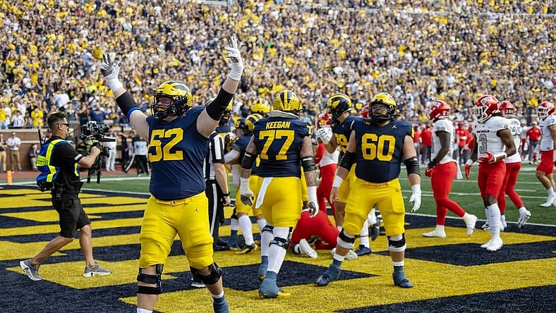 Sep 9, 2023; Ann Arbor, Michigan, USA; Michigan Wolverines defensive end Kechaun Bennett (52) celebrates running back Blake Corum   s (2) touchdown during the first half at Michigan Stadium. Mandatory Credit: David Reginek-USA TODAY Sports