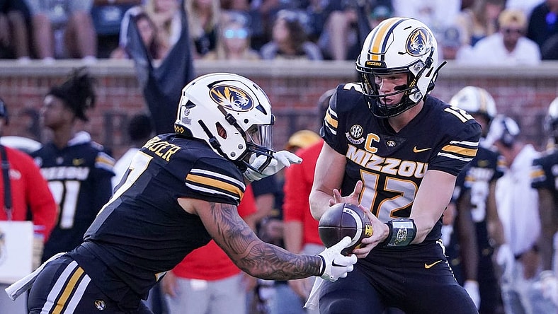 Sep 9, 2023; Columbia, Missouri, USA; Missouri Tigers quarterback Brady Cook (12) hands off to running back Cody Schrader (7) against the Middle Tennessee Blue Raiders during the first half at Faurot Field at Memorial Stadium. Mandatory Credit: Denny Medley-USA TODAY Sports