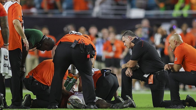 Sep 9, 2023; Miami Gardens, Florida, USA; Miami Hurricanes head coach Mario Cristobal looks on as trainers check on Miami Hurricanes safety Kamren Kinchens (5) after an injury against the Texas A&M Aggies during the fourth quarter at Hard Rock Stadium. Mandatory Credit: Sam Navarro-USA TODAY Sports