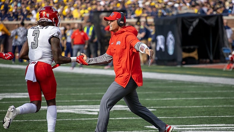 Sep 9, 2023; Ann Arbor, Michigan, USA; UNLV Rebels Defensive Coordinator/Linebackers Mike Scherer slaps hand with defensive back Johnathan Baldwin (3) after a fourth down stand against the Michigan Wolverines during the first half at Michigan Stadium. Mandatory Credit: David Reginek-USA TODAY Sports