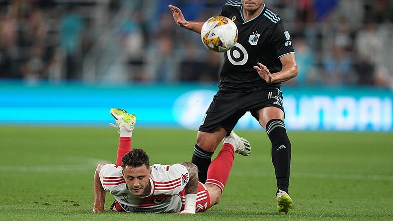 Sep 9, 2023; Saint Paul, Minnesota, USA;  New England Revolution forward Giacomo Vrioni (9) and Minnesota United defender Miguel Tapias (4) battle for the ball during the first half at Allianz Field. Mandatory Credit: Matt Blewett-USA TODAY Sports