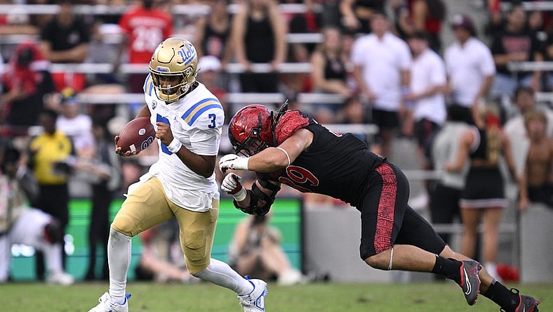 Sep 9, 2023; San Diego, California, USA; UCLA Bruins quarterback Dante Moore (3) runs the ball while defended by San Diego State Aztecs defensive lineman Garret Fountain (39) during the first half at Snapdragon Stadium. Mandatory Credit: Orlando Ramirez-USA TODAY Sports