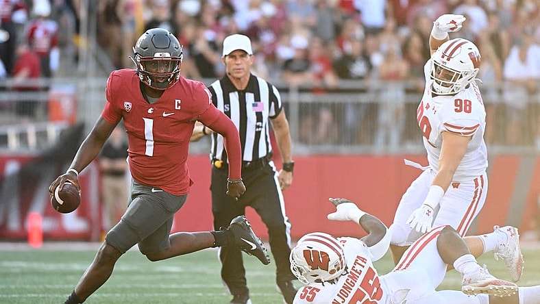 Sep 9, 2023; Pullman, Washington, USA; Washington State Cougars quarterback Cameron Ward (1) is chased out of the pocket by Wisconsin Badgers linebacker Maema Njongmeta (55) in the first half at Gesa Field at Martin Stadium. Mandatory Credit: James Snook-USA TODAY Sports