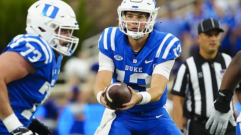 Sep 9, 2023; Durham, North Carolina, USA;  Duke Blue Devils quarterback Riley Leonard (13) gets ready to hand the ball off against the Lafayette Leopards during the first half at Wallace Wade Stadium. Mandatory Credit: James Guillory-USA TODAY Sports