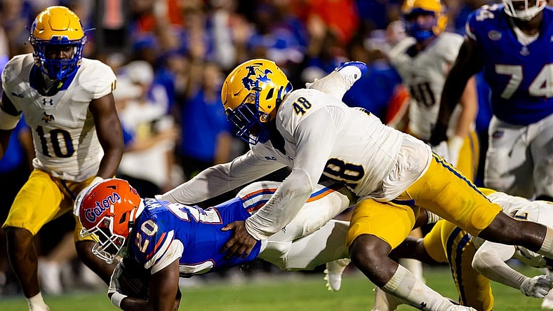 Sep 9, 2023; Gainesville, Florida, USA; Florida Gators running back Treyaun Webb (20) stretches for a first down tackled by McNeese State Cowboys linebacker Micah Davey (48) during the second half at Ben Hill Griffin Stadium. Mandatory Credit: Matt Pendleton-USA TODAY Sports