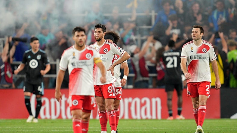 Sep 9, 2023; Saint Paul, Minnesota, USA; New England Revolution midfielder Carles Gil (10) and midfielder Matt Polster (8) and defender Ryan Spaulding (34) and defender Dave Romney (2) react after a game-tying goal by Minnesota United in stoppage time at Allianz Field. Mandatory Credit: Matt Blewett-USA TODAY Sports