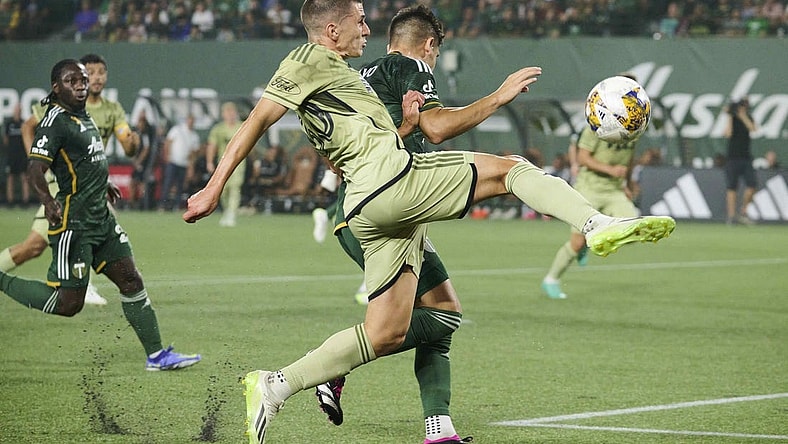 Sep 9, 2023; Portland, Oregon, USA; Los Angeles FC defender Sergi Palencia (30) takes a shot on goal during the first half against Portland Timbers defender Claudio Bravo (5) at Providence Park. Mandatory Credit: Troy Wayrynen-USA TODAY Sports