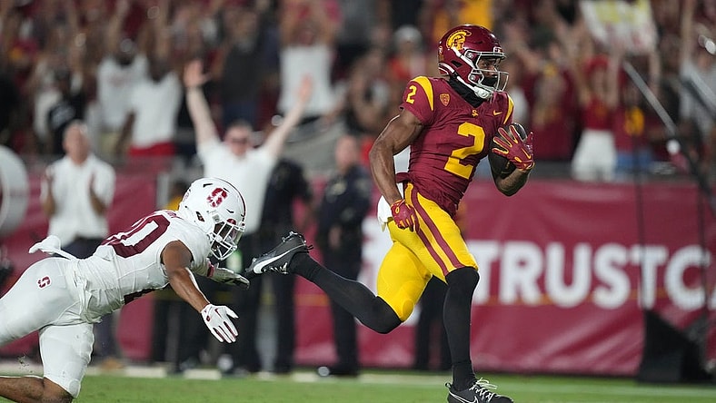 Sep 9, 2023; Los Angeles, California, USA; Southern California Trojans wide receiver Brenden Rice (2) scores on a 75-yard touchdown reception against Stanford Cardinal cornerback Jaden Slocum (20) in the first half at United Airlines Field at Los Angeles Memorial Coliseum. Mandatory Credit: Kirby Lee-USA TODAY Sports