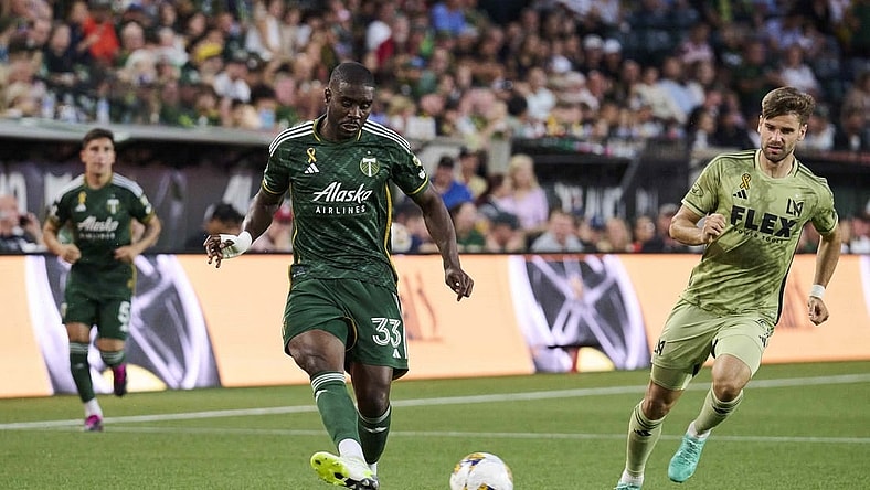 Sep 9, 2023; Portland, Oregon, USA; Portland Timbers defender Larrys Mabiala (33) kicks the ball during the first half against Los Angeles FC forward Mario Gonzalez (9) at Providence Park. Mandatory Credit: Troy Wayrynen-USA TODAY Sports