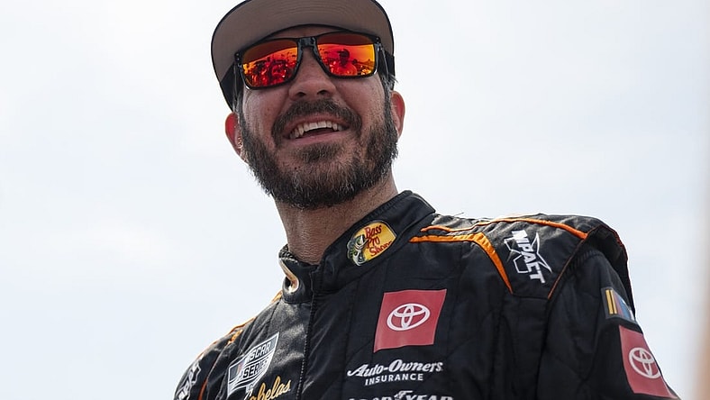 Sep 10, 2023; Kansas City, Kansas, USA; NASCAR Cup Series driver Martin Truex Jr. (19) smiles on the grid before the NASCAR Cup Series Hollywood Casino 400 at Kansas Speedway. Mandatory Credit: Amy Kontras-USA TODAY Sports