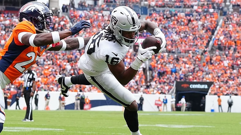 Sep 10, 2023; Denver, Colorado, USA;  Las Vegas Raiders wide receiver Jakobi Meyers (16) catches a touchdown pass with Denver Broncos cornerback Damarri Mathis (27) defending in the first quarter at Empower Field at Mile High. Mandatory Credit: Ron Chenoy-USA TODAY Sports