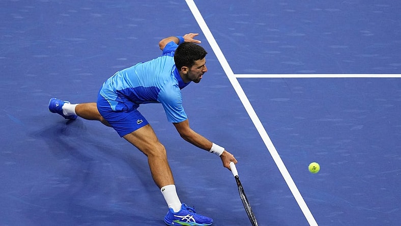 Sep 10, 2023; Flushing, NY, USA; Novak Djokovic of Serbia reaches for a forehand against Daniil Medvedev (not pictured) in the men's singles final in the men's singles final on day fourteen of the 2023 U.S. Open tennis tournament at USTA Billie Jean King National Tennis Center. Mandatory Credit: Danielle Parhizkaran-USA TODAY Sports