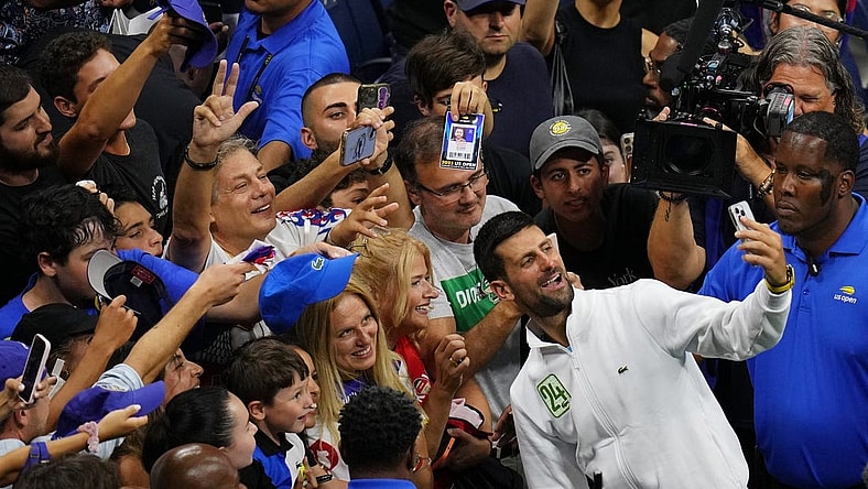 Sep 10, 2023; Flushing, NY, USA; Novak Djokovic of Serbia takes a selfie with fans after his match against Daniil Medvedev (not pictured) in the men's singles final in the men's singles final on day fourteen of the 2023 U.S. Open tennis tournament at USTA Billie Jean King National Tennis Center. Mandatory Credit: Danielle Parhizkaran-USA TODAY Sports
