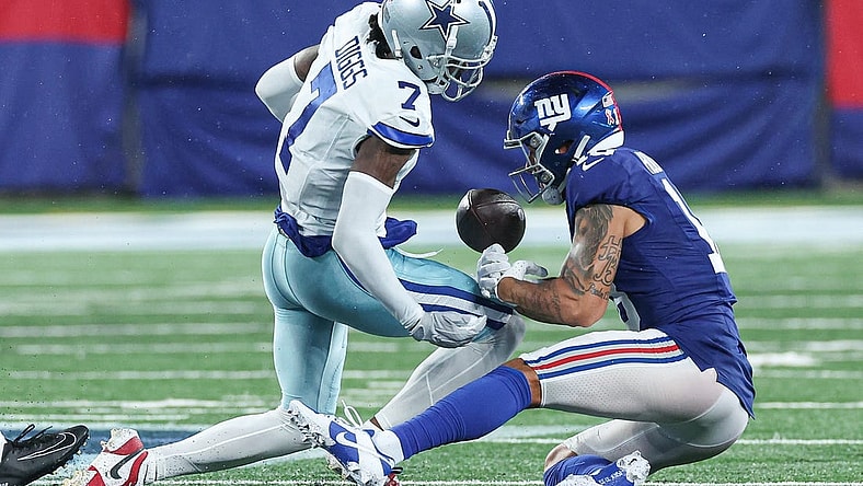 Sep 10, 2023; East Rutherford, New Jersey, USA; Dallas Cowboys cornerback Trevon Diggs (7) forces a fumble by New York Giants wide receiver Isaiah Hodgins (18) during the second half at MetLife Stadium. Mandatory Credit: Vincent Carchietta-USA TODAY Sports