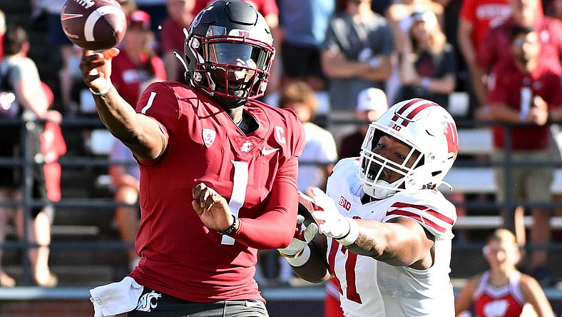 Sep 9, 2023; Pullman, Washington, USA; Washington State Cougars quarterback Cameron Ward (1) against Wisconsin Badgers defensive lineman Will McDonald (77) in the first half at Gesa Field at Martin Stadium. Mandatory Credit: James Snook-USA TODAY Sports