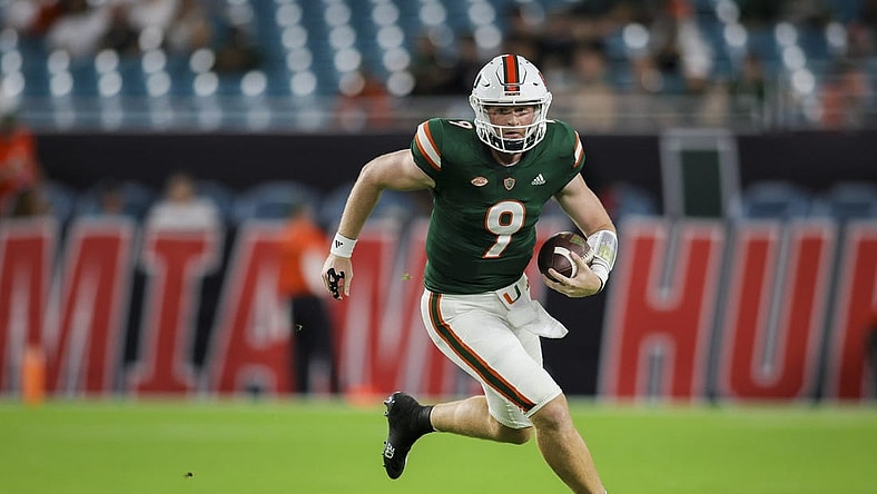 Sep 14, 2023; Miami Gardens, Florida, USA; Miami Hurricanes quarterback Tyler Van Dyke (9) runs with the football against the Bethune Cookman Wildcats during the first quarter at Hard Rock Stadium. Mandatory Credit: Sam Navarro-USA TODAY Sports