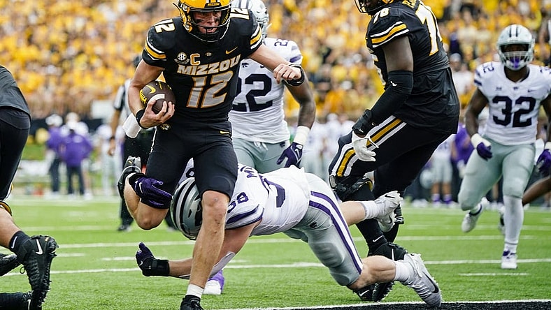Sep 16, 2023; Columbia, Missouri, USA; Missouri Tigers quarterback Brady Cook (12) scores a touchdown against Kansas State Wildcats defensive end Brendan Mott (38) during the first half at Faurot Field at Memorial Stadium. Mandatory Credit: Jay Biggerstaff-USA TODAY Sports