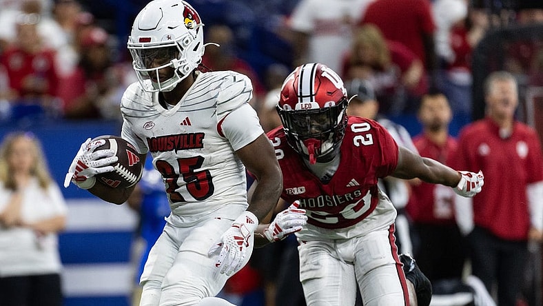 Sep 16, 2023; Indianapolis, Indiana, USA; Louisville Cardinals running back Jawhar Jordan (25) runs for a touchdown against Indiana Hoosiers defensive back Louis Moore (20) in the second quarter at Lucas Oil Stadium. Mandatory Credit: Trevor Ruszkowski-USA TODAY Sports