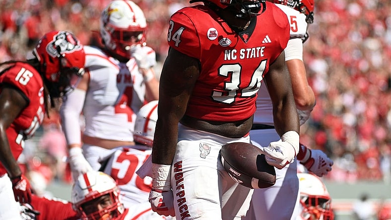 Sep 16, 2023; Raleigh, North Carolina, USA; North Carolina State Wolfpack running back Delbert Mimms III (34) celebrates a touchdown during the first half against the Virginia Military Institute Keydets at Carter-Finley Stadium. Mandatory Credit: Rob Kinnan-USA TODAY Sports