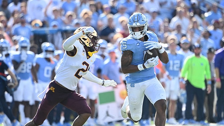 Sep 16, 2023; Chapel Hill, North Carolina, USA;  North Carolina Tar Heels wide receiver J.J. Jones (5) catches the ball as Minnesota Golden Gophers defensive back Tre'Von Jones (2) defends in the second quarter at Kenan Memorial Stadium. Mandatory Credit: Bob Donnan-USA TODAY Sports