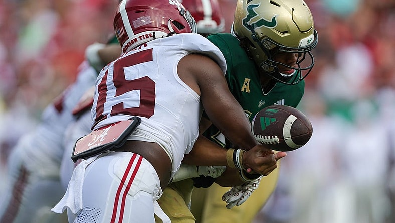 Sep 16, 2023; Tampa, Florida, USA;  *Alabama Crimson Tide linebacker Dallas Turner (15) forces a fumble by South Florida Bulls quarterback Byrum Brown (17) in the second quarter at Raymond James Stadium. Mandatory Credit: Nathan Ray Seebeck-USA TODAY Sports