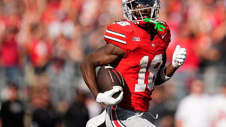 Sep 16, 2023; Columbus, Ohio, USA; Ohio State Buckeyes wide receiver Marvin Harrison Jr. (18) runs for a 75-yard touchdown catch during the first half of the NCAA football game against the Western Kentucky Hilltoppers at Ohio Stadium.