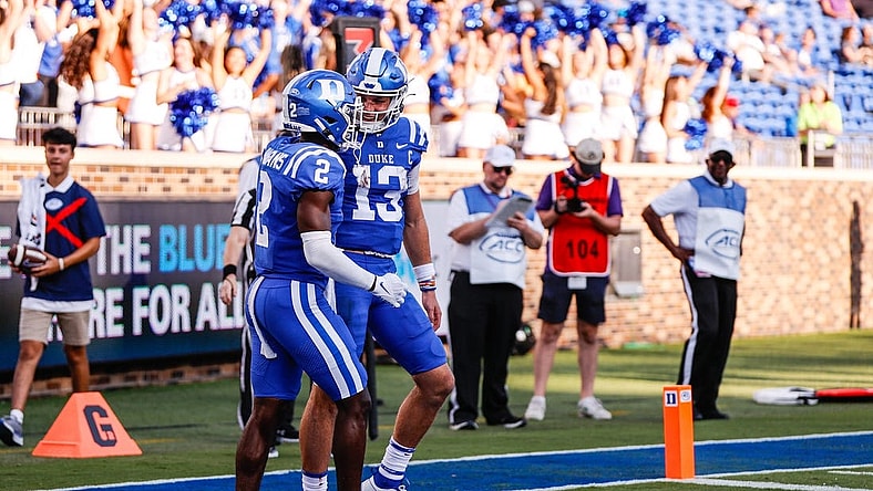 Sep 16, 2023; Durham, North Carolina, USA; Duke Blue Devils quarterback Riley Leonard (13) scores a touchdown and celebrates with wide receiver Sahmir Hagans (2) during the second half against Northwestern Wildcats at Wallace Wade Stadium. Mandatory Credit: Jaylynn Nash-USA TODAY Sports