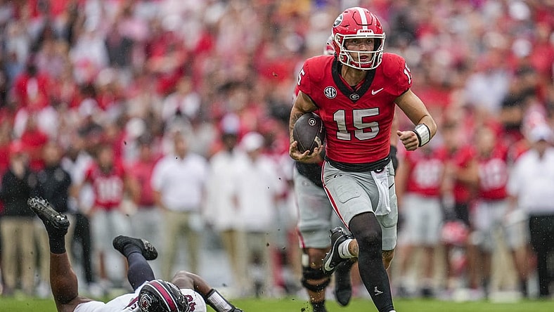 Sep 16, 2023; Athens, Georgia, USA; Georgia Bulldogs quarterback Carson Beck (15) runs past South Carolina Gamecocks defensive end Bryan Thomas Jr. (46) during the first half at Sanford Stadium. Mandatory Credit: Dale Zanine-USA TODAY Sports