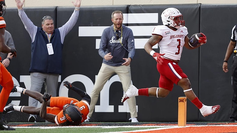 Sep 16, 2023; Stillwater, Oklahoma, USA; South Alabama Jaguars running back La'Damian Webb (3) runs past Oklahoma State Cowboys safety Trey Rucker (9) to score a touchdown at Boone Pickens Stadium. Mandatory Credit: Bryan Terry-USA TODAY Sports