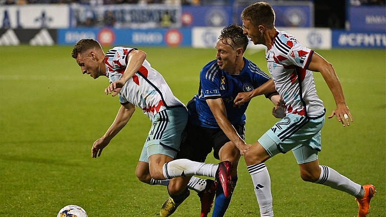 Sep 16, 2023; Montreal, Quebec, CAN; Chicago Fire forward Fabian Herbers (21) is tackled by CF Montreal midfielder Lassi Lappalainen (21) in the first half at Stade Saputo. Mandatory Credit: David Kirouac-USA TODAY Sports