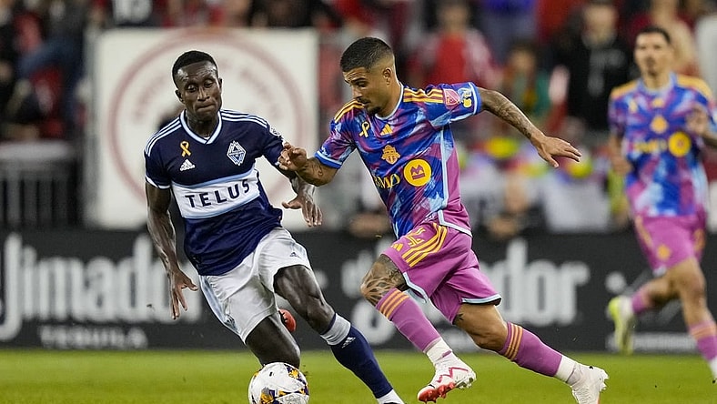 Sep 16, 2023; Toronto, Ontario, CAN; Toronto FC forward Lorenzo Insigne (24) moves the ball against Vancouver Whitecaps defender Richie Laryea (7) during the first half at BMO Field. Mandatory Credit: Kevin Sousa-USA TODAY Sports