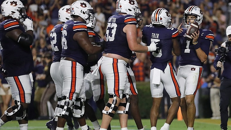 Sep 16, 2023; Auburn, Alabama, USA; Auburn Tigers quarterback Payton Thorne (1) celebrates with teammates after scoring a touchdown against the Samford Bulldogs during the second quarter at Jordan-Hare Stadium. Mandatory Credit: John Reed-USA TODAY Sports
